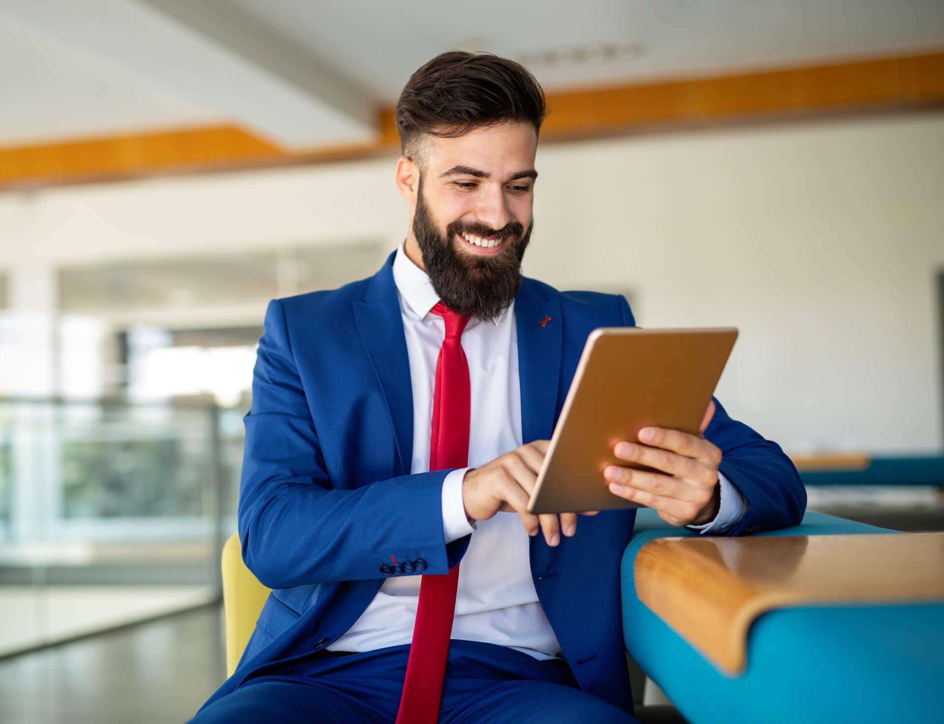 business-man-working-on-his-tablet-in-the-office-K2KHEJW.jpeg